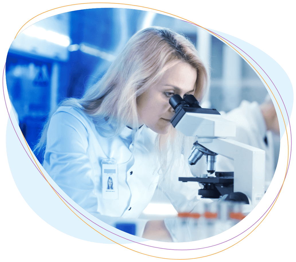 Woman scientist looking through microscope.